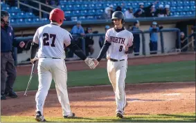  ?? BARRY BOOHER — FOR THE NEWS-HERALD ?? North’s Devo Britsky (27) congratula­tes John Lanning during the Rangers’ victory over South on April 25at Classic Park.