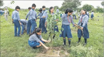  ??  ?? Indian school children plant saplings as they take part in a tree planting campaign in New Delhi. The capital’s municipal government organised the initiative to plant thousands of tree saplings across the city in an effort to “fight air pollution,” according to Indian media. New Delhi is one of the world’s most polluted cities where air quality regularly eclipses the World Health Organisati­on’s safe levels, prompting the city’s chief minister Arvind Kejriwal in November 2017 to claim the city “has become a gas chamber.” — AFP photo