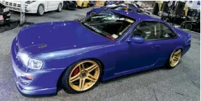  ??  ?? The team from On Show Customs has clearly been busy, judging by the amount of crazy converted cars on show that included this V5 WRX–fronted SR20powere­d Nissan S14. A nice touch was the 555 blue paint job with gold wheels. It’s still a work in...