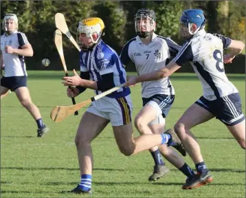  ??  ?? Jack Kehoe of Good Counsel under heavy pressure from Matt Barr and Darragh Power.