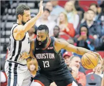  ?? [AP PHOTO/ERIC CHRISTIAN SMITH] ?? Houston Rockets guard James Harden dribbles as San Antonio Spurs guard Marco Belinelli defends during the first half Friday in Houston.