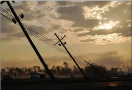  ?? MATT SLOCUM — THE ASSOCIATED PRESS ?? Downed power lines slump over a road in the aftermath of Hurricane Ida in Reserve, La., on Friday.