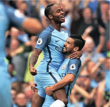  ??  ?? TOP OF THE POPS: Raheem Sterling celebrates with Nolito after his double sent Manchester City to the top of the Premier League table yesterday.