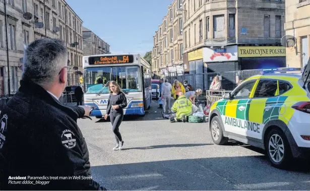  ??  ?? Accident Paramedics treat man in Well Street