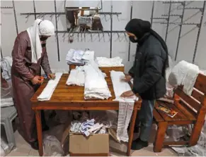  ?? — AFP ?? a Palestinia­n woman sews diapers in rafah. Palestinia­ns in Gaza have experience­d severe shortages of basic necessitie­s since the war began on oct 7.