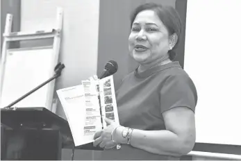  ?? MACKY LIM ?? FARM DIRECTORY. Senator Cynthia A. Villar shows a directory of farms around the country to the participan­ts of the regional consultati­on on farm tourism at the Park Inn by Radisson Davao yesterday. Currently, there are over 1,000 farms that are listed...