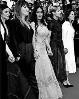  ?? GISELA SCHOBER/GETTY ?? Salma Hayek, center, and other women protest Saturday on the Cannes Film Festival’s red carpet.