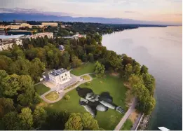  ?? — AP ?? In this photo a giant landart painting entitled “Message From Future” by French artist Saype, is pictured in the park “La Perle du Lac” in Geneva, Switzerlan­d, on Sunday. The artwork covering 5000 square meters was produced with biodegrada­ble paints made from natural pigments. The artist called the little girl "Future" as a symbol of the generation­s from the future and the small origami boats that she drops into Lake Geneva aims to represent a message of hope sent to the world.