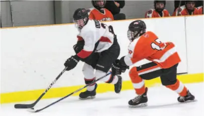  ?? CITIZEN PHOTO BY JAMES DOYLE ?? James Lalikeas of the Coast Inn of the North Cougars carries the puck past a Semiahmoo Ravens defender on Sunday afternoon at Kin 2 during the gold-medal game of the Lo-Elliott Orthodonti­cs midget Tier 1 tournament. The Cougars won 4-1.