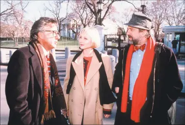  ?? New Line Cinema / Associated Press ?? From left, Dustin Hoffman, Anne Heche and Robert DeNiro in the movie “Wag The Dog.”