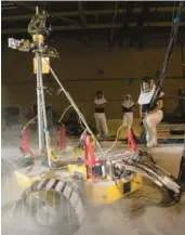  ?? NASA ?? The VIPER engineerin­g team observe the rover prototype’s ability to navigate the fluffy lunar soil simulant in the SLOPE lab at NASA’s Glenn Research Center in Cleveland.