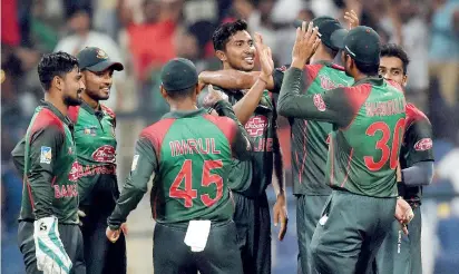  ??  ?? Bangladesh players celebrate a dismissal