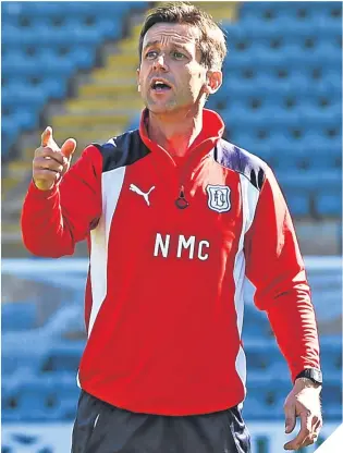  ??  ?? Neil McCann takes his first training session at Dens Park.