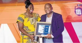  ?? CONTRIBUTE­D PHOTOS ?? For her work ethic and commitment to Sandals Royal Caribbean, Judine Thompson receives the Pacesetter Award from Hotel Manager of Sandals Royal Caribbean Lancelot Lebert, at the resort’s annual staff awards this year.