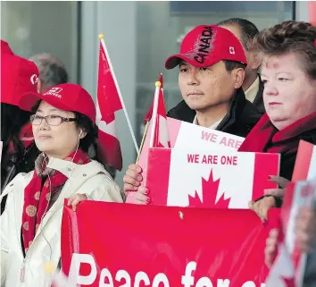  ?? — NICK PROCAYLO/PNG ?? A group of Richmond residents of Chinese descent, who chose Canada to be their home, demonstrat­e to urge people to stand up and say no to racism and to show their love for the community Sunday.