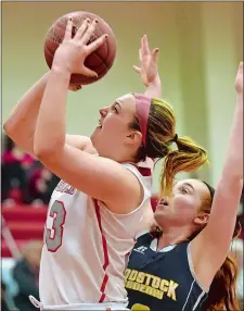  ?? TIM MARTIN/THE DAY ?? St. Bernard’s Caitlyn Dittman, left, shoots over Woodstock Academy’s Jamie Woods during Wednesday night’s ECC Division II final at NFA. Dittman had 11 points, nine rebounds and four blocked shorts, but the No. 2 Saints fell to the No. 4 Centaurs 47-22.