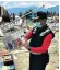  ??  ?? Windy Mantong, 17, top, is among 80 missing Bible Camp children after the church they were in was swept three miles away from its location by a mudslide. Above, a member of the search team picks up a religious book near the ruins of the church, right