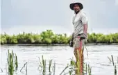  ?? BRIAN ROEDEL / NATIONAL GEOGRAPHIC VIA AP ?? Anthony Mackie wades in the Bayous near Violet, La., during the filming of “Shark Beach with Anthony Mackie.”