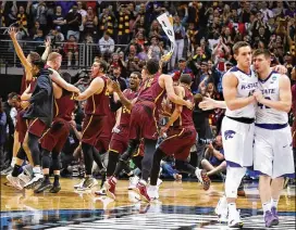  ?? CURTIS COMPTON / CCOMPTON@AJC.COM ?? Loyola-Chicago players celebrate after defeating Kansas State 78-62 in the South Regional final at Philips Arena on Saturday.