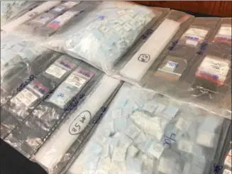  ?? ERIC DEVLIN — DIGITAL FIRST MEDIA ?? Fifty grams of heroin, distribute­d among 1,600 packets were laid on table during a press conference Wednesday detailing the results of a Montgomery County Investigat­ive Grand Jury’s report on the opioid crisis.