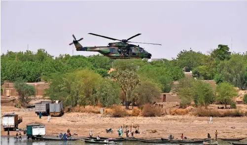  ?? | EPA ?? FRENCH President Emmanuel Macron flies over Gao in northern Mali. UN and AU support are key to France’s counterter­rorism operations in the area, according to the writers.