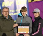  ??  ?? Myles Hewlett of United Striders receiving his Mr Oil athlete of the month award from Paddy Morgan (Athletics Wexford) and Marie Mooney from Mr Oil.