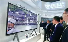  ?? ZHU XINGXIN / CHINA DAILY ?? Attendees visit the China Mobile exhibition booth promoting 5G communicat­ion technology on Thursday during the Fifth World Internet Conference in Wuzhen, Zhejiang province.