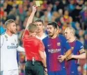  ?? AFP ?? Referee Alejandro Hernandez shows yellow card to Luis Suarez.