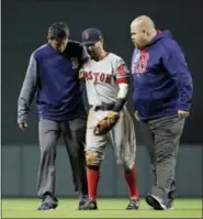  ?? PATRICK SEMANSKY - THE ASSOCIATED PRESS ?? Boston Red Sox second baseman Dustin Pedroia, center, is assisted off the field after being injured during the eighth inning against the Baltimore Orioles Friday in Baltimore.