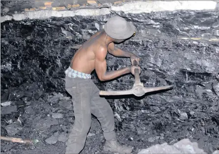  ?? PICTURES: MARK OLALDE ?? HIS ONLY JOB: An illegal miner digs coal undergroun­d at a former Anker coal operation outside Ermelo. “There is no employment, and if you want to put food on the table you must come here,” Vincent Mashinini says.