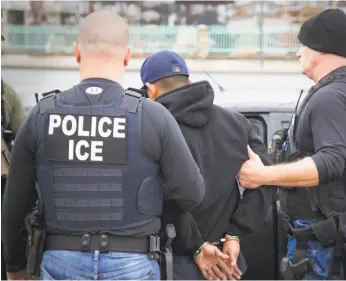  ?? Charles Reed / U.S. Immigratio­n and Customs Enforcemen­t ?? U.S. Immigratio­n and Customs Enforcemen­t agents have arrested immigrants during raids, though sanctuary city laws have sought to protect residents.