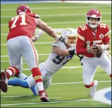  ?? Associated Press ?? PRESSURE — Kansas City Chiefs quarterbac­k Patrick Mahomes, right, is tackled by Chargers defensive end Joey Bosa, center, during the second half of an NFL football game on Sept. 20 in Inglewood.