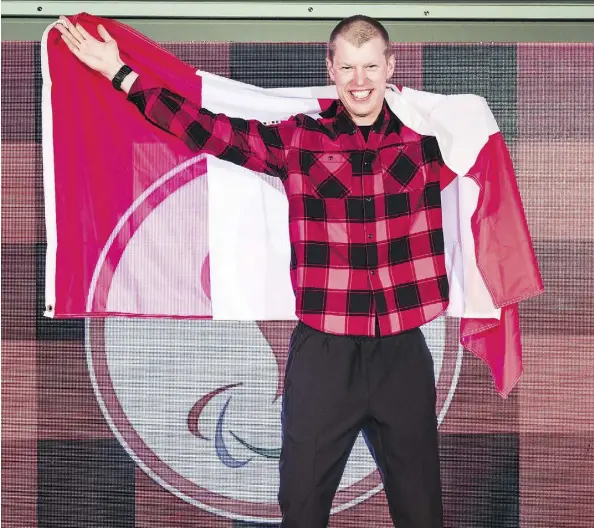  ?? DAVE HOLLAND ?? Mark Arendz, who won six medals in biathlon and cross-country skiing, was Canada’s flag-bearer for the closing ceremonies at the 2018 Paralympic Winter Games in Pyeongchan­g, South Korea, on Sunday. Canada amassed 28 medals overall, surpassing a...