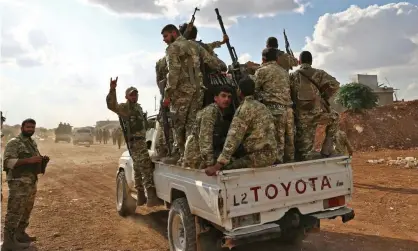  ?? Photograph: Nazeer Al-Khatib/AFP via Getty Images ?? Turkish-backed Syrian fighters near Aleppo, as US forces begin pulling back from areas along the Syrian-Turkish border.