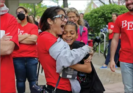  ?? STUART CAHILL / HERALD STAFF ?? GOOD TO SEE YOU: Teacher Graciela Mohamedi hugs 5th grade student John Montrose, 11, as the teachers union celebrates its new contract with the city of Brookline on Tuesday