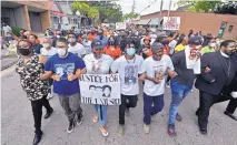  ?? HYOSUB SHIN/ATLANTA JOURNAL-CONSTITUTI­ON ?? A crowd marches Saturday in Brunswick, Georgia, after a rally at the Glynn County Courthouse to protest the shooting of Ahmaud Arbery.