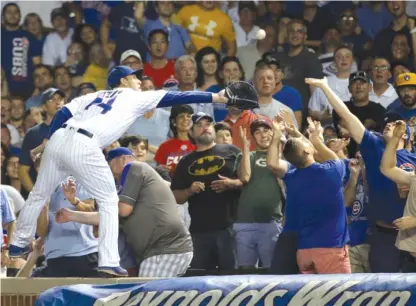  ?? | GETTY IMAGES ?? Anthony Rizzo makes a highlight- reel catch for an out while standing on the wall in the fifth inning of the nightcap Tuesday.