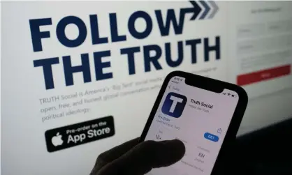  ?? Photograph: Chris Delmas/AFP/Getty Images ?? ‘Abusing truth as only he can’: a smartphone user checks the app store for Truth Social.