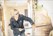  ?? Lauren Noess ?? NICOLE CURTIS of “Rehab Addict” searches for brick in the walls of one of her restoratio­n projects.