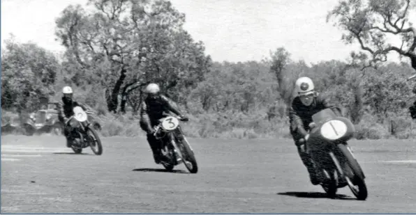  ??  ?? BELOW Entering the main straight, Geoff Duke leads Peter Nicol and George Scott.