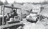  ?? AP FILE ?? Officials remove the truck at a quarry in Livermore in which 26 children and their bus driver were held.