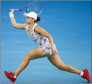  ?? HAMISH BLAIR — THE ASSOCIATED PRESS ?? No. 1seed Ash Barty plays a forehand return to Lesia Tsurenko of Ukraine during their first round match at the Australian Open Monday. Barty won easily, 6-0, 6-1.