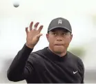  ?? PETER CASEY/USA TODAY SPORTS ?? Tiger Woods catches a ball as he practices on the driving range Tuesday at Bethpage.