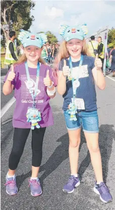  ?? Picture: RICHARD GOSLING ?? Charlize Hamilton and Ava Latimer, both 8, were decked out in “merch” for the gymnastics at Coomera.