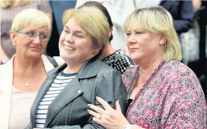  ??  ?? > Victims Judith Conduit, left, Patricia Welch and Frances Perks react as they leave Nottingham Crown Court