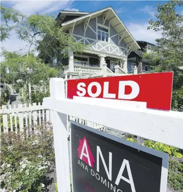  ?? MARK VAN MANEN / POSTMEDIA NEWS ?? West side houses and condos for sale in Vancouver. B.C.’s new 15-per- cent tax on foreign homebuyers should help cool the market, Moody’s Investors Service said Wednesday.