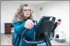  ?? ?? Donna Cooper shows her exercise bike at her home in Front Royal, Va., on March 1, 2024. Generally, Cooper maintains her fitness regimen with walks with friends. (AP)