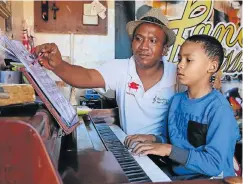  ?? Picture: WERNER HILLS ?? IN TUNE: Children at Pandora’s Musical Box are getting ready for their December 8 concert. Here Verrick Erasmus gives Adriano Prince, 8, some guidance on the piano