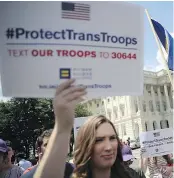  ?? — GETTY IMAGES ?? Gay rights supporters were at the U.S. Capitol in Washington D.C. condemning the new ban on transgende­r service members on Wednesday.