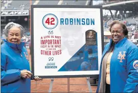  ?? KATHY WILLENS — THE ASSOCIATED PRESS ?? Rachel Robinson, left, widow of Jackie Robinson, and daughter Sharon stand with a plaque honoring Jackie on Jackie Robinson Day, held Sunday in New York before a game between the New York Mets and the Milwaukee Brewers.